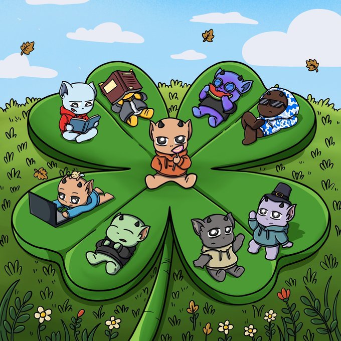 A whimsical illustration shows various colorful demon-like characters relaxing on the leaves of a giant four-leaf clover in a grassy field with falling autumn leaves.