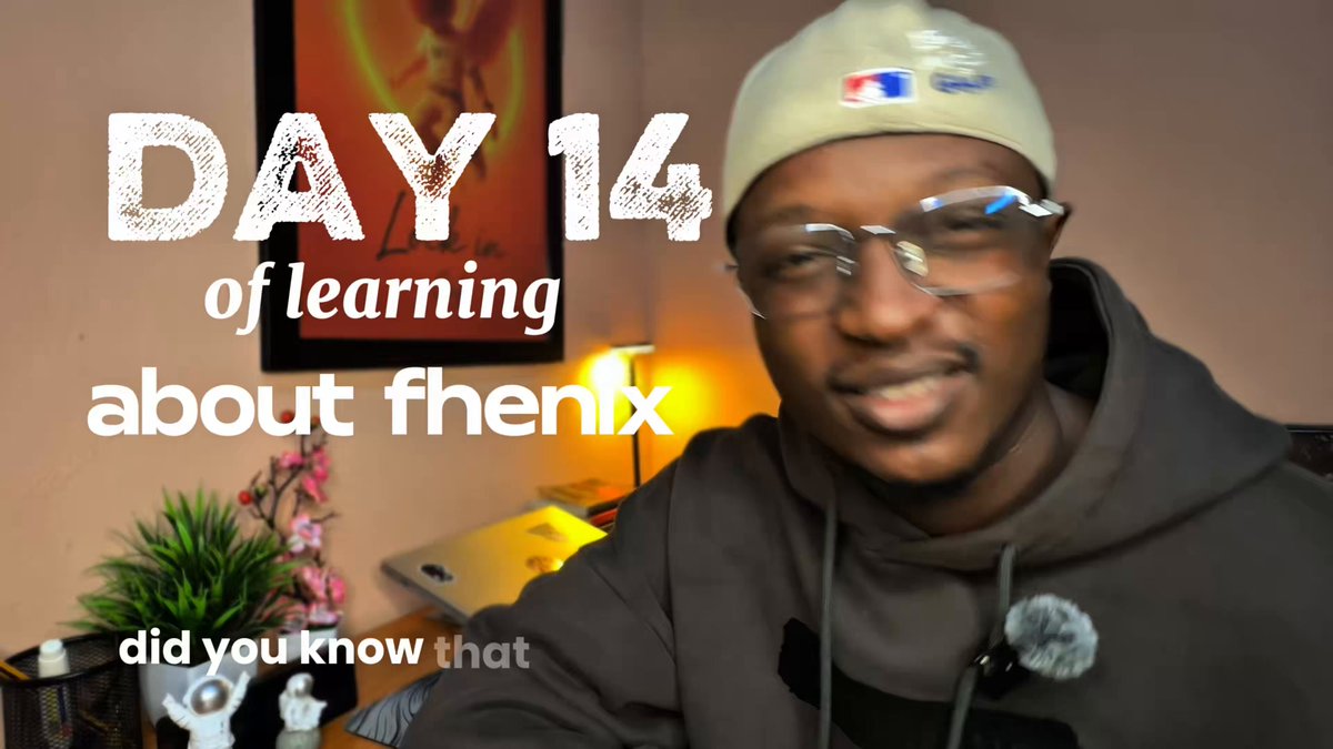 The image features a man wearing glasses, a hat, and a hoodie with the number 14 displayed prominently across his face. The text "day 14 of learning about @fhenix" is written above him, indicating that he has been sharing information or knowledge related to the subject on this day. The background includes a desk with a lamp and a potted plant, suggesting an indoor setting like a home office or study area.