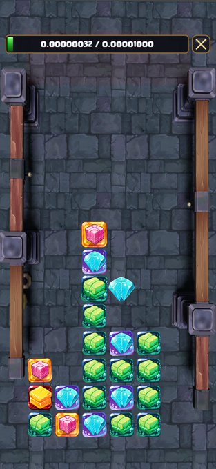 A screenshot from the mobile puzzle game "bitfight" shows a stone-textured playing field with stacked colorful gems, with a tiny progress bar at the top displaying "0.00000032 / 0.00010000." The scene ties to the post's announcement about a $60 prize pool distributed to the top 3 players in bitfight for VRnouns and iPhone owners.
