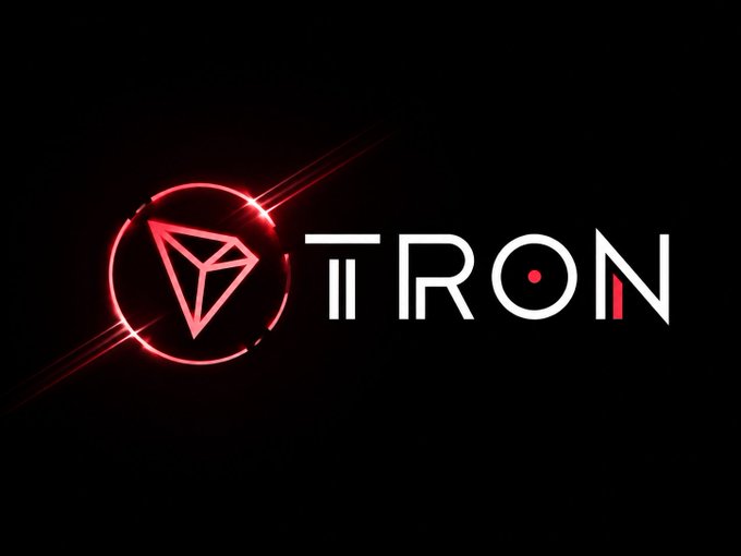 A glowing red TRON logo with its diamond-shaped icon appears on a black background, representing the cryptocurrency network.