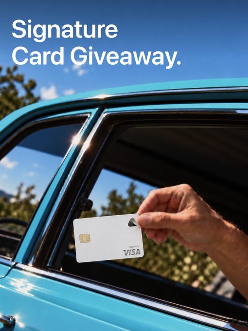 A hand extends a Visa-branded credit card from the open window of a turquoise vintage car against a blue sky, with "Signature Card Giveaway." prominently displayed above. The image visually promotes the giveaway of 5 Signature cards, capturing the act of receiving the card as if being handed through a car window.