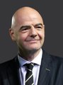 A headshot of Gianni Infantino, the President of FIFA, wearing a dark suit and striped tie.