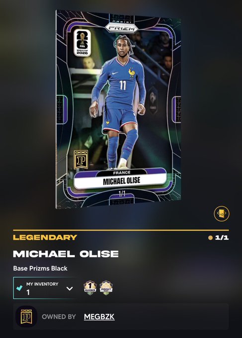 A digital trading card featuring soccer player Michael Olise in a blue France kit, marked as 'LEGENDARY' and 'Base Prizms Black', owned by 'MEGBZK' with a 1/1 rarity indicator.