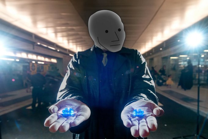 A masked figure in a black jacket stands in what appears to be a subway station, holding two glowing blue crystals in outstretched palms.