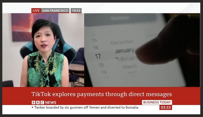 A BBC News broadcast shows a split screen with a reporter in a floral green top on the left and a close-up of a finger scrolling through months on a tablet on the right, with the headline 'TikTok explores payments through direct messages'.