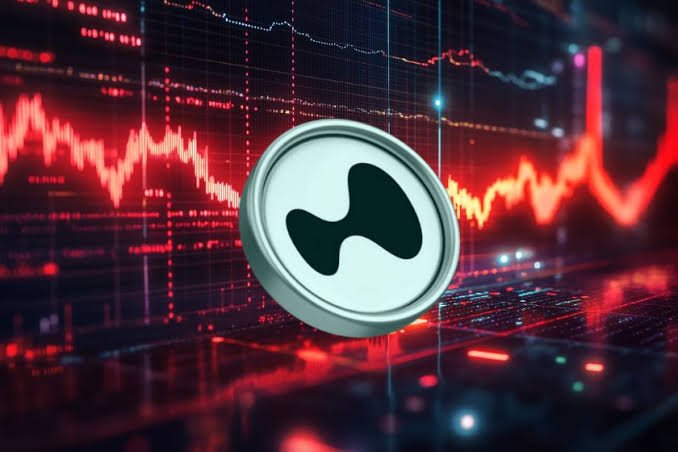 A cryptocurrency coin with a distinctive logo floats against a backdrop of red trading charts and financial data visualizations.