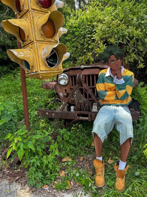 An anime-styled photo edit showing a character with green hair, a yellow and green striped shirt, and denim shorts posing thoughtfully next to a rusty old traffic light and vintage vehicle in an overgrown outdoor setting.