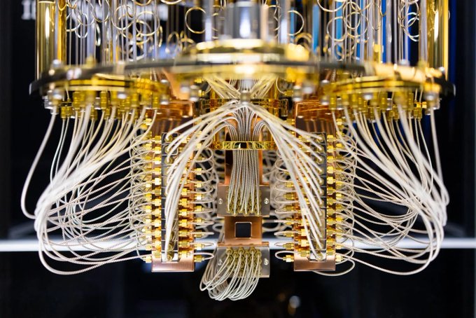 A close-up view of an intricate quantum computer's hardware, featuring gleaming gold-colored processors interconnected by a dense web of white cables. This advanced technology visually represents the post's announcement of Neurai's "Positronic" update, which introduces quantum-resistant algorithms to protect against future quantum computing threats.