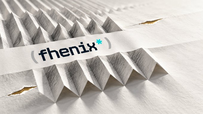 A close-up of textured white folded paper displays the black-and-blue “(* fhenix*)” logo, or “( fhenix* ),” centered on the surface.