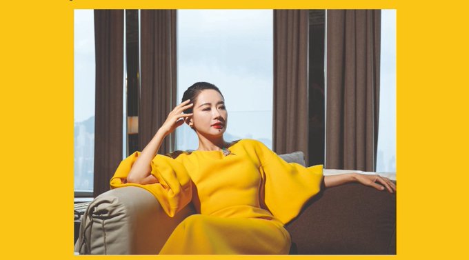 The image features a woman sitting on a couch wearing a yellow dress. The background of the photo shows a window with curtains, suggesting that she might be indoors or in an indoor setting like a living room. The caption provided about her life story is not directly related to the image but could be interpreted as a connection between the woman's appearance and the post.