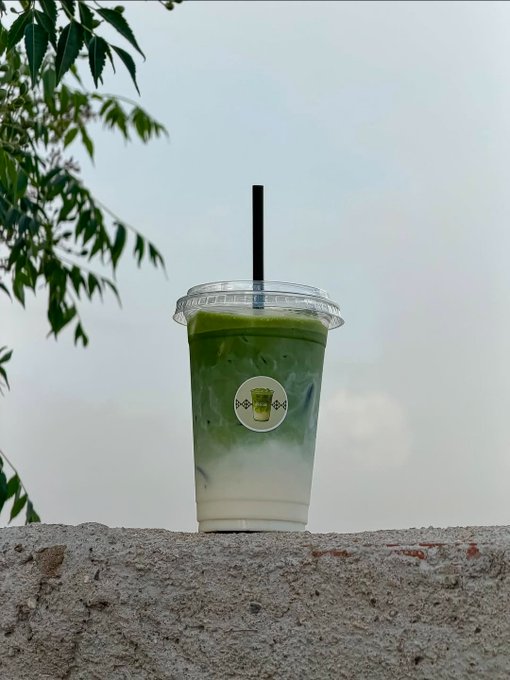 The image features a cup of green tea sitting on top of a rock wall, with a tree behind it. The scene suggests that someone has placed the cup there as part of their outdoor experience or picnic setup. The focus of the image seems to be more on the tea and its surroundings rather than directly addressing the post about computing security.