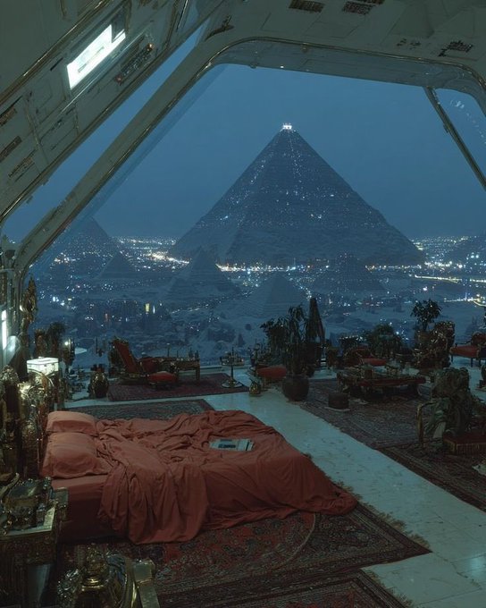 The image shows a bedroom with an orange bedspread, surrounded by potted plants and other furniture items such as chairs and tables. The room has a large window overlooking a city skyline at night, which creates a serene atmosphere. The photo is captioned "Good Night. Infrastructure creates possibilities. Community creates permanence. Stablecoins make value move efficiently, but lasting ecosystems are built when people find reasons to return". This message suggests that the bedroom's design and location offer an ideal environment for relaxation and contemplation, while also highlighting the importance of sustainable living and community-based initiatives in creating a better future.

The image is related to the post "Good Night. Infrastructure creates possibilities. Community creates permanence. Stablecoins make value move efficiently, but lasting ecosystems are built when people find reasons to return". The bedroom's design and location provide an ideal setting for sustainable living and community-based initiatives, as it encourages a connection with nature and fosters a sense of belonging within the community.