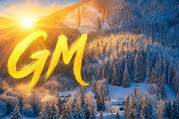 Golden morning light streams over a snow-covered mountain forest, with the stylized yellow letters "GM" (Good Morning) brushed across the scene — a warm seasonal greeting fitting the post's reminder that winter is approaching and Q4 is prime time for both ski trips and BTC buying opportunities.