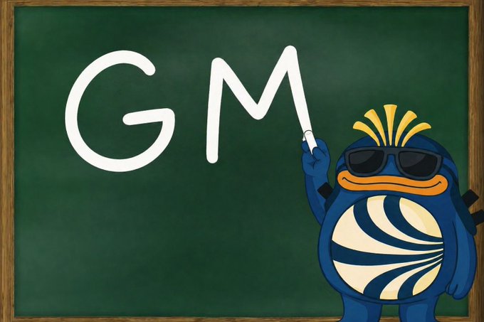 A cartoon blue character wearing sunglasses and a yellow crown-like tuft writes 'GM' (Good Morning) in large white letters on a green chalkboard.