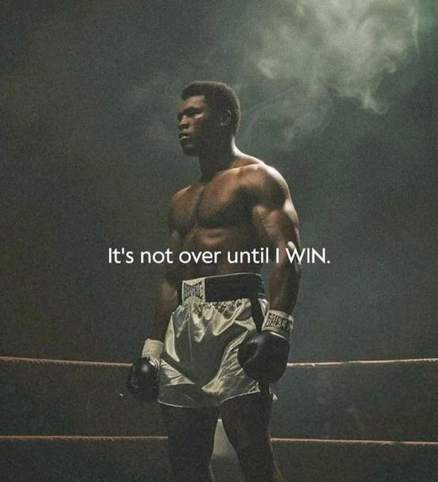 A muscular Black boxer stands in a boxing ring wearing Everlast gloves and shorts, with the motivational text 'It's not over until I WIN.' overlaid on the image.