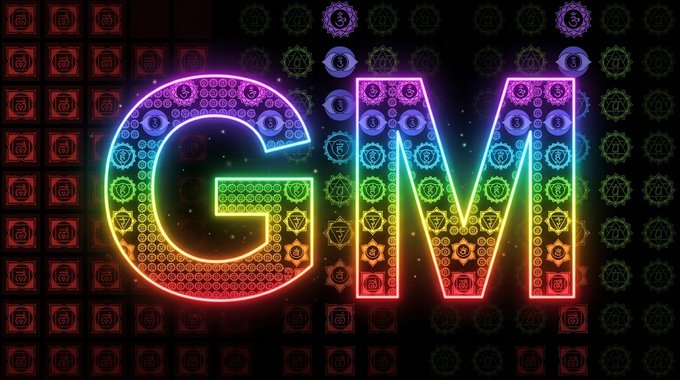 A colorful neon sign displaying the letters 'GM' against a dark backdrop filled with ornate decorative patterns.