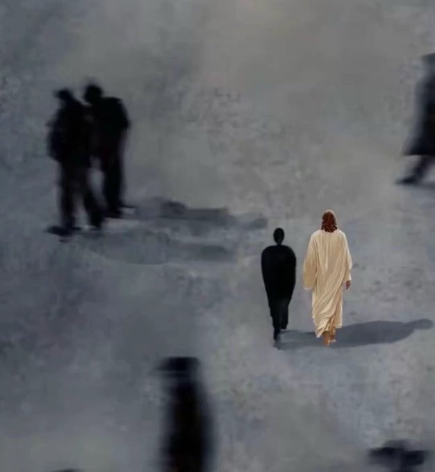 Artistic image showing a figure resembling Jesus in white robes walking alongside a dark shadow figure, with blurred silhouettes of other people in the background.