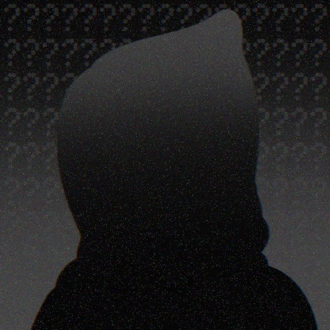 A dark silhouette of a hooded figure is barely visible against a heavily grainy, dark background, obscuring any identifying details.