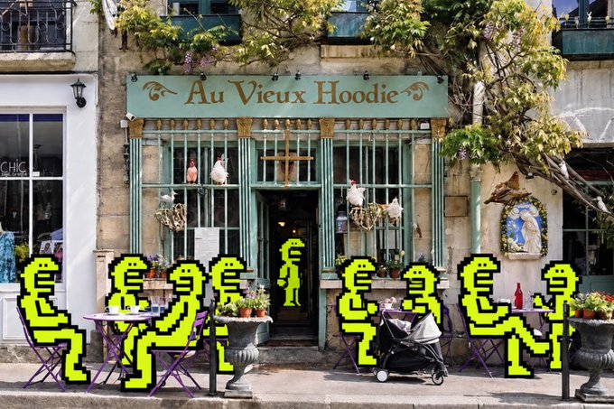 A storefront with a green sign reading 'Au Vieux Hoodie', decorated with hanging planters and bird figures, with pixelated yellow figures sitting at outdoor cafe tables.