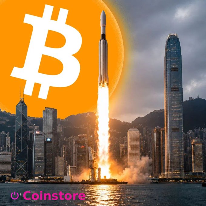 A promotional image featuring a Bitcoin logo with a rocket launching against an orange background and a city skyline, branded with the 'Coinstore' logo.