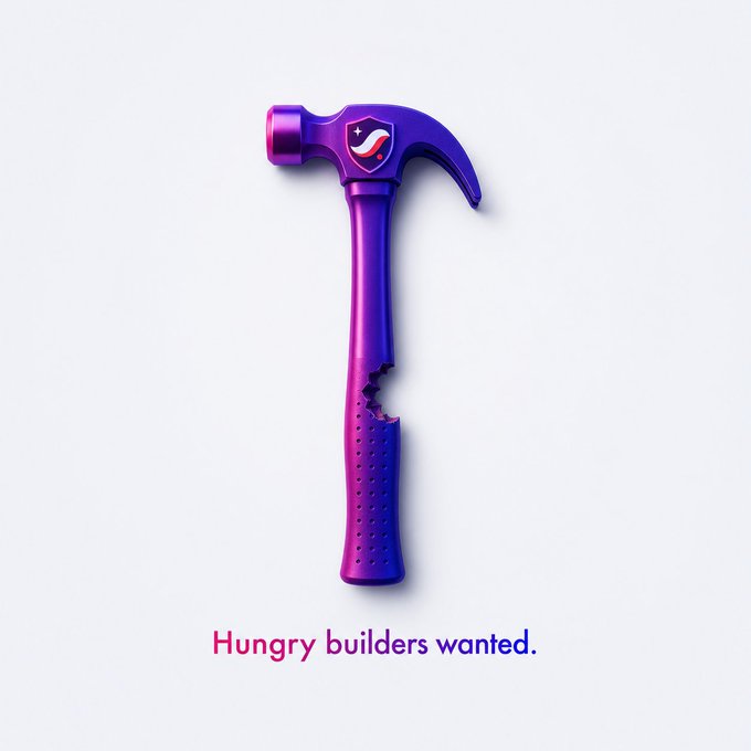 A purple and pink gradient 3D rendered hammer with a bite taken out of its handle, featuring a shield logo and the tagline 'Hungry builders wanted.'