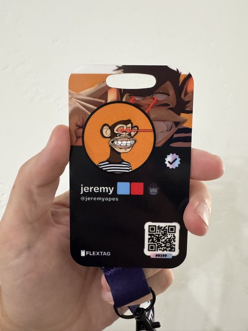 A hand holding a black NFT ID card labeled "FLEXTAG" with the name "jeremy" and handle "@jeremyapes", featuring a grinning monkey avatar and a QR code.
