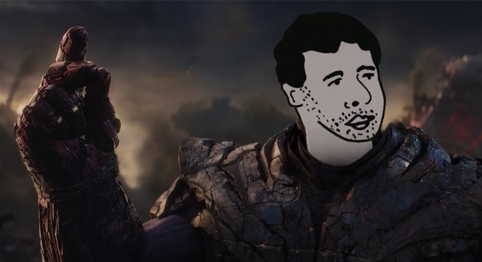 A digitally edited image shows the simple drawn "Wojak" face meme superimposed onto a dark, armored warrior in a smoky battlefield setting.