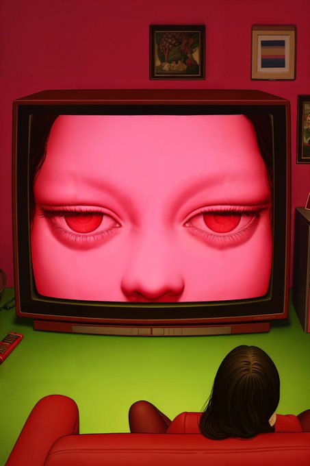 A person with dark hair sits on a red couch in a red-walled room, watching an old CRT television that displays a giant pink face with striking red eyes. The eerie, unsettling scene relates to the "GM Friends!" post by creating a haunting contrast between the cheerful greeting and the unsettling, almost supernatural atmosphere of the image.