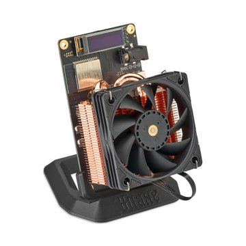 A compact electronic device featuring a copper heatsink assembly with heat pipes, a small black cooling fan, and an OLED display mounted on a black stand, branded 'TITAN'.