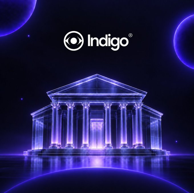 The Indigo logo displayed above a glowing blue holographic Greek/Roman temple with columns against a dark space background with planets.