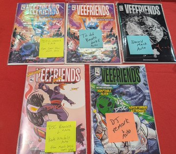 Five "VEEFRIENDS" comic books are laid out on a red surface, each marked with colorful sticky notes featuring handwritten labels such as "DJ Remix Auto," "Space Hawk Auto," "Toad Breaks Auto," and "Jack Knows It All," indicating they have been sent off for CGC grading as referenced in the post.