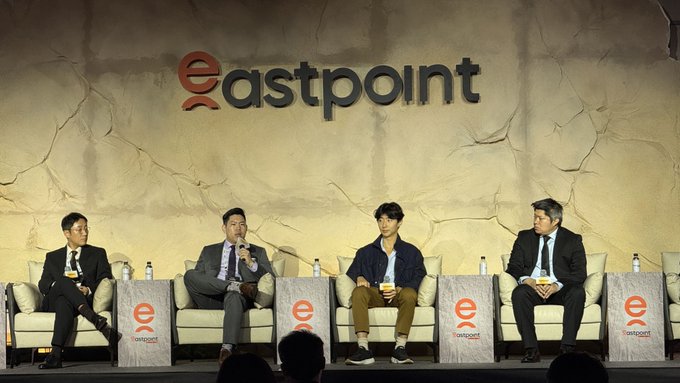 Four panelists sit on stage at the Eastpoint Seoul conference, with the "eastpoint" logo prominently displayed behind them on a cracked stone-textured backdrop. The panel includes Plume CEO Chris Yin, alongside representatives from Monad and other industry leaders, discussing tokenized assets and live markets.
