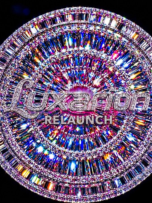 A sparkling, diamond-encrusted circular display showcases the 'Luxafior Relaunch' logo with multicolored gemstone accents.