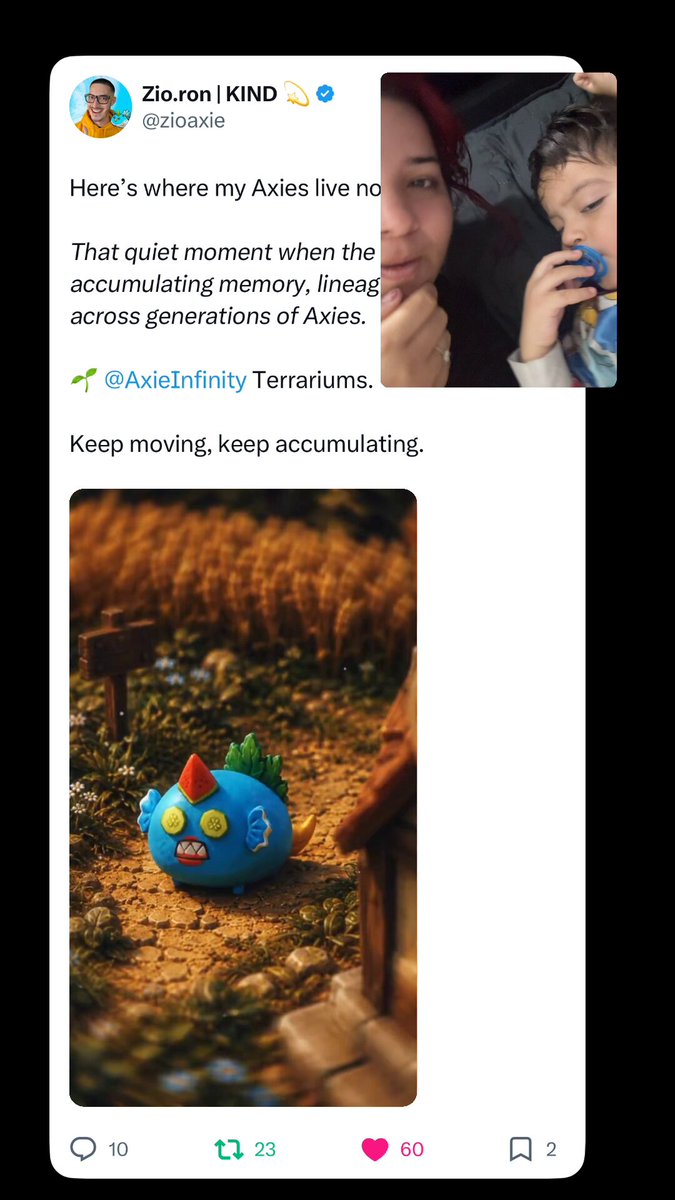 The image features a twitter profile where there are various posts related to social media content, including one about baby reactions to Zio's video of Axis Infinity. The photo shows a baby interacting with an object resembling a dragon or monster from a video game called "Axis" on a cell phone screen. The post says that the image is for sharing and contains a caption about the baby's reaction to the video, expressing their love for it.