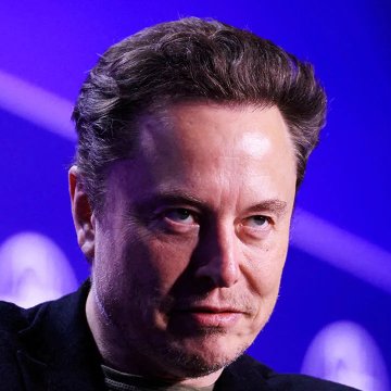 A close-up of Elon Musk, the world's richest man, pictured against a blue background as he comments on Bitcoin being based on energy.