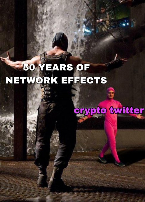 The image is a meme depicting Bane from *The Dark Knight Rises* standing triumphantly with arms outstretched, labeled "50 YEARS OF NETWORK EFFECTS," as a man in a pink morph suit labeled "crypto twitter" dances behind him. The post draws a parallel between TradFi's long-established network effects (Bane) overshadowing the often-mocked crypto community (the dancing pink figure), mocking crypto Twitter's tendency to belittle traditional finance only to be surprised when TradFi successfully adopts similar technology.