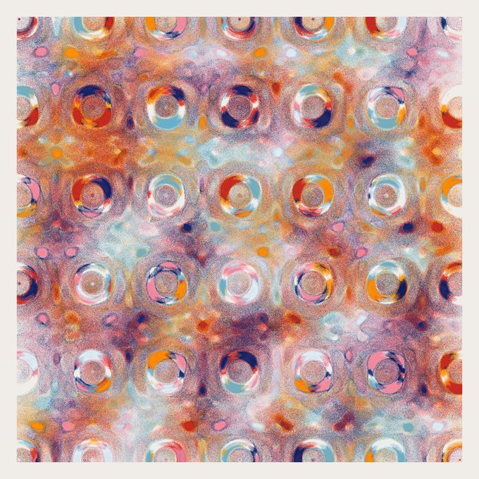 An abstract patterned image featuring a grid of colorful circular dots in orange, blue, pink, and white tones against a watercolor-style background.