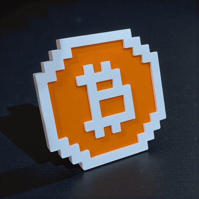A 3D rendering of a Bitcoin symbol in white and orange sits on a dark surface.