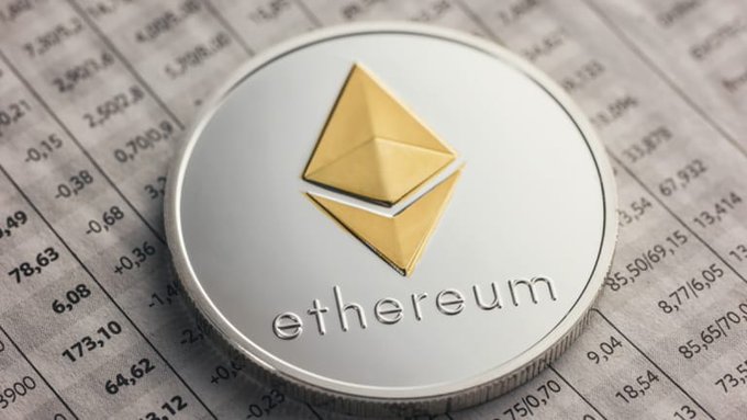 urn of gold and silver, with a yellow triangle at the center, labeled "ETHEREUM" against a gray background.