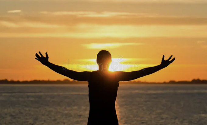 A silhouette of a person stands with arms outstretched against a golden sunset over water, embodying the open, expansive spirit of "cypherpunk summer." The radiating sunbeams and horizon evoke themes of liberation and possibility aligned with the cypherpunk ethos.