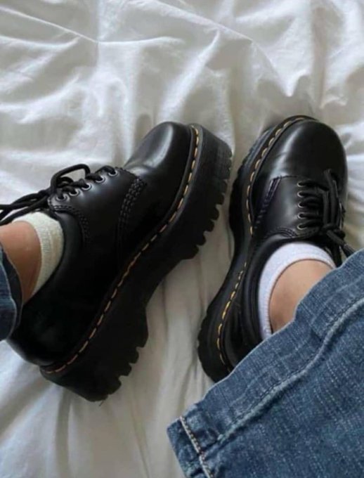 "Ghvd Mvrning Lovelies" is a brand of black dress shoes, which are described as having a "smaller than per user fine-tuning according to @TheARCTERMINAL It works across GPT-4o, Claude & Grok simultaneously." The image shows two pairs of black dress shoes with gold accents and white socks.