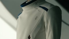 The image shows a sleek white and navy futuristic garment or uniform with structured shoulders, displayed on a mannequin. The post from "@vladtenev" teasing "going somewhere new" aligns with the forward-looking, sci-fi aesthetic of the apparel, suggesting a new product or concept reveal.