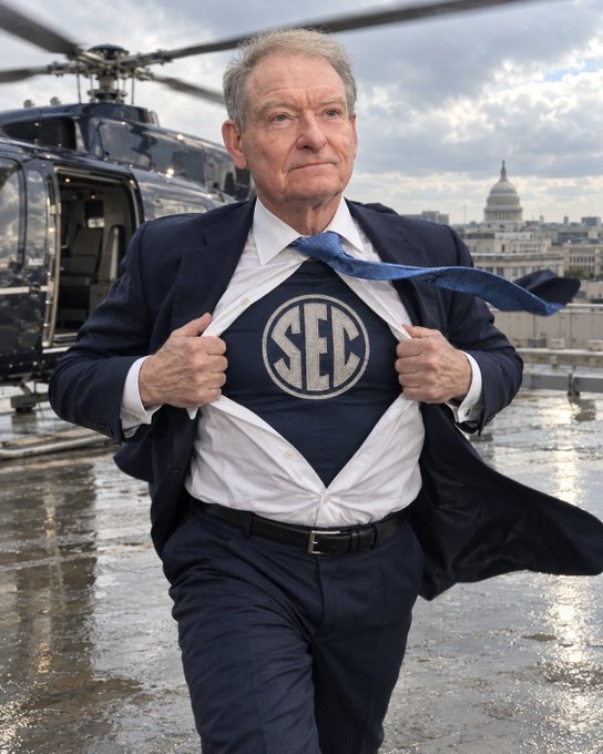 SEC Chair Paul Atkins reveals a superhero shirt emblazoned with the SEC logo as he prepares to swoop in on crypto regulation, stepping out of a helicopter against the backdrop of the U.S. Capitol following the CLARITY Act's failure to advance in the Senate.