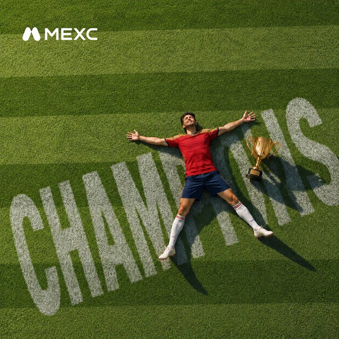 A victorious soccer player lies on the field next to a trophy, with the word "CHAMPIONS" written in the grass, alongside the MEXC logo. The image visually represents victory and achievement, mirroring the post's congratulatory message to Spain and its call to action for conquering markets on MEXC.