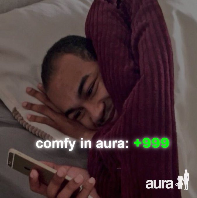 An advertisement showing a smiling person in bed looking at a phone, with text 'comfy in aura: +999' and the 'aura' logo.