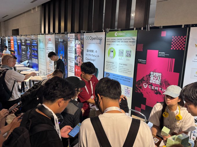 Crowds of attendees gather at Booth S-20 during WebX_Asia, where CertiK's AI Auditor and AI Skill Scanner demos are prominently displayed on the branded wall alongside neighboring exhibitor banners such as Openloop, Oddiy, and Intellic Learn.