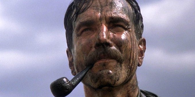 A close-up of a weathered, dirt-covered man with a thick mustache holding a pipe in his mouth, looking worn and contemplative against a cloudy sky. The image's rugged, "battle-tested" look humorously contrasts with the post's discussion of "time-tested" privacy wallets in the RAILGUN ecosystem, visually reinforcing the idea of endurance and weathering in the crypto space.