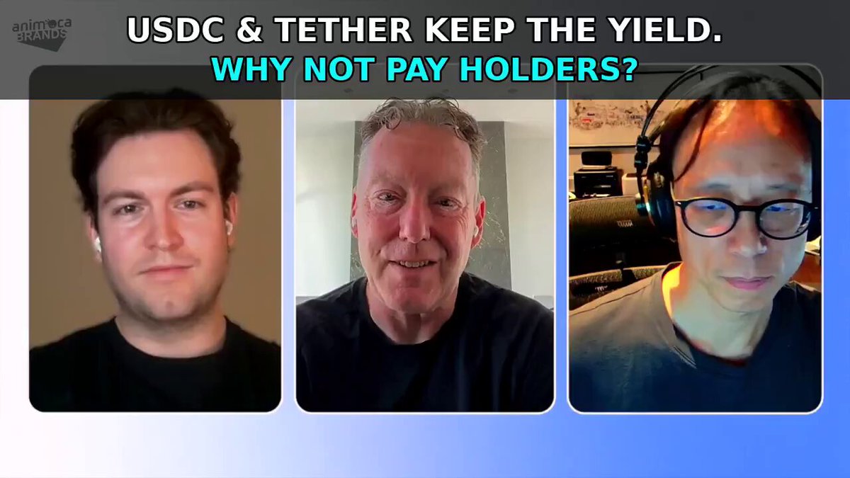 The image features three men, each wearing headphones, sitting behind a desk. They are all smiling for the camera, creating an engaging atmosphere. The background of the image has a blue hue that complements their smiles. The caption below the image reads "Why not pay holders?". This phrase is related to the discussion about stablecoins and their yield in the post.