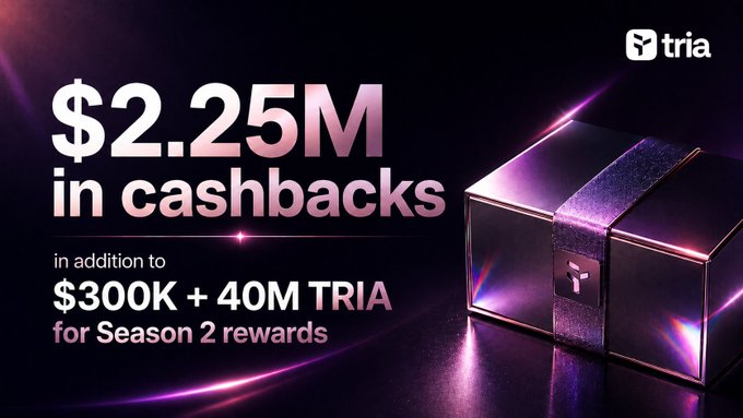 The image features a purple box with a gold ribbon sitting on top of a table. The text above the box reads "Happy Friday @useTria mates Crypto has unlocked new possibilities, but using it still feels fragmented. Tria changes that by bringing wallets, payments, rewards, and spending into a single experience".
