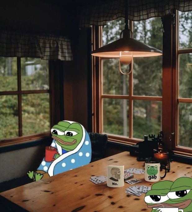 A cozy cabin interior featuring Pepe the Frog meme characters playing cards at a wooden table; one holds a red drink while another has a mug labeled "gab" next to cards and a shot glass marked "No.".
